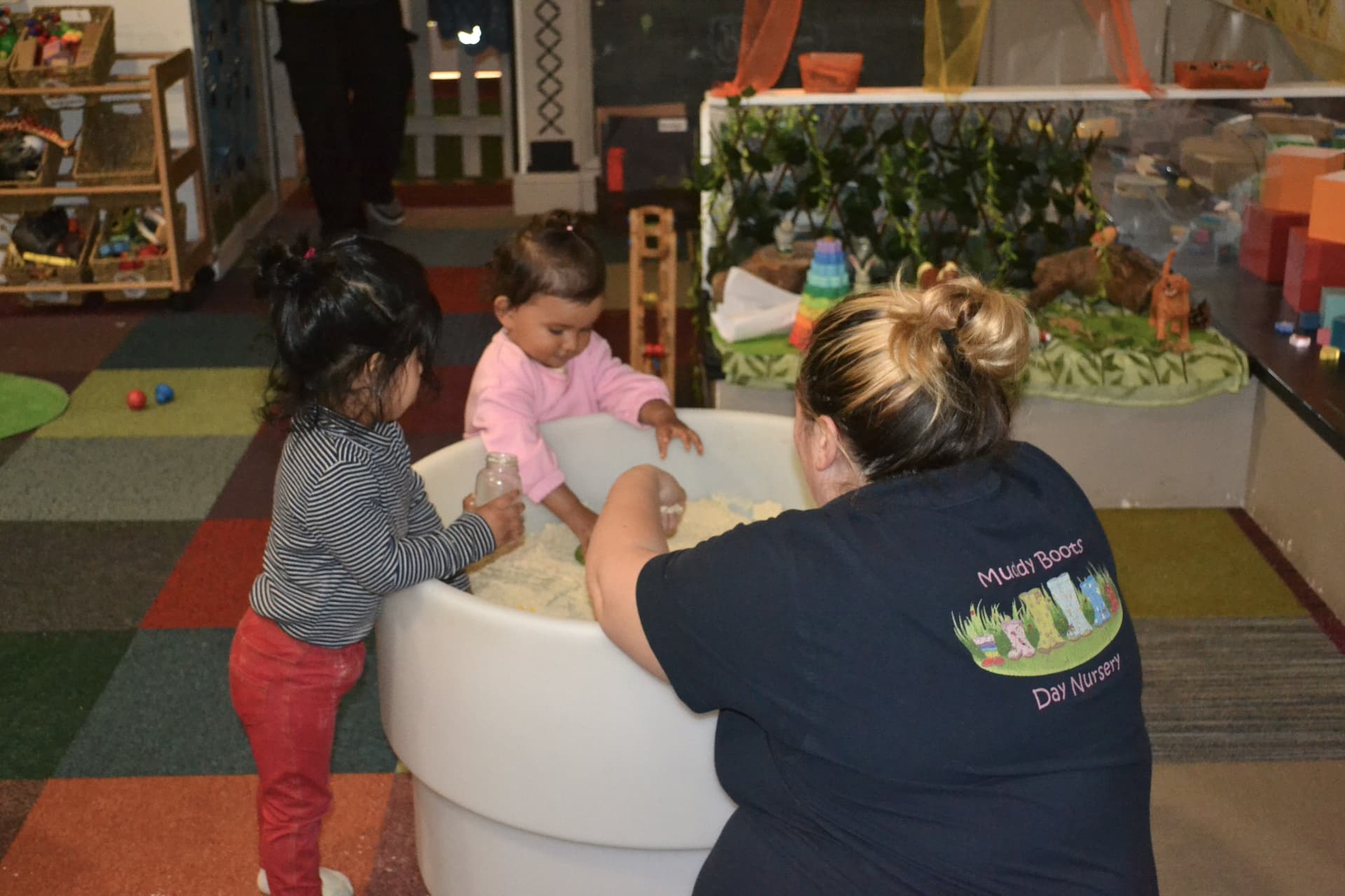 Babies exploring sensory play with their key person