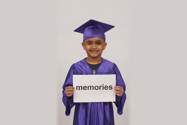 Graduate in cap and gown holding a word card: memories