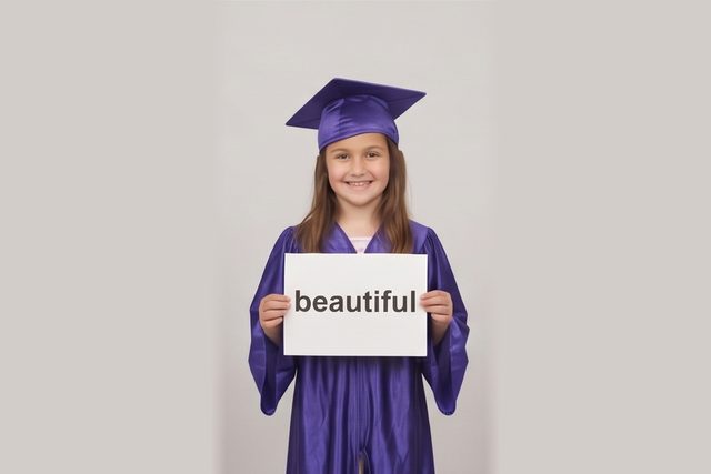 Graduate in cap and gown holding a word card: beautiful