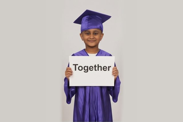 Graduate in cap and gown holding a word card: Together